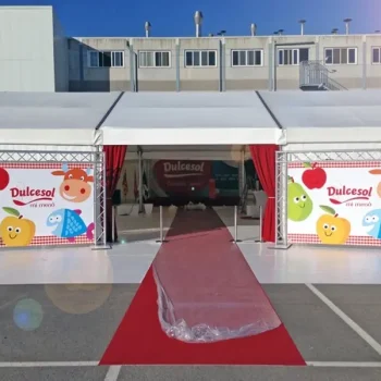 Entrada del evento corporativo de Dulcesol, con una alfombra roja frente a una carpa blanca.